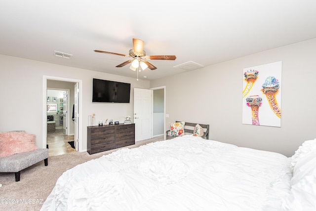 carpeted bedroom with visible vents and ceiling fan