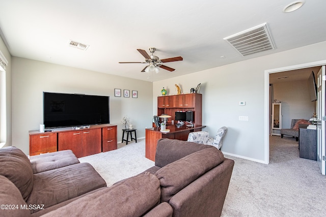 living room with baseboards, visible vents, and light colored carpet