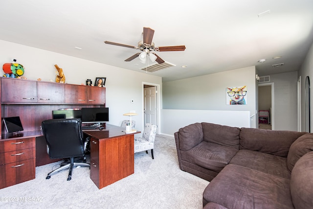 office with light carpet, visible vents, and a ceiling fan