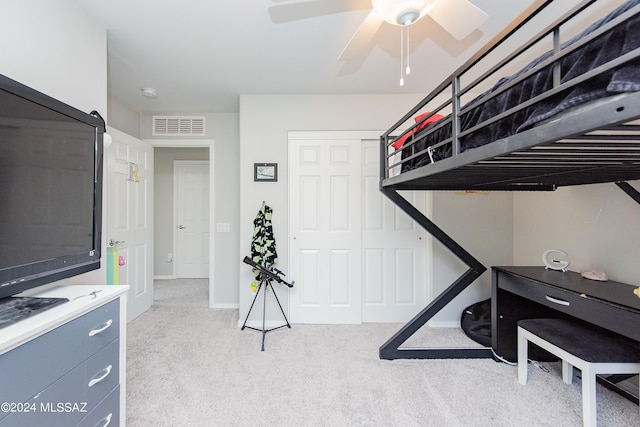 carpeted bedroom featuring baseboards, a closet, visible vents, and a ceiling fan