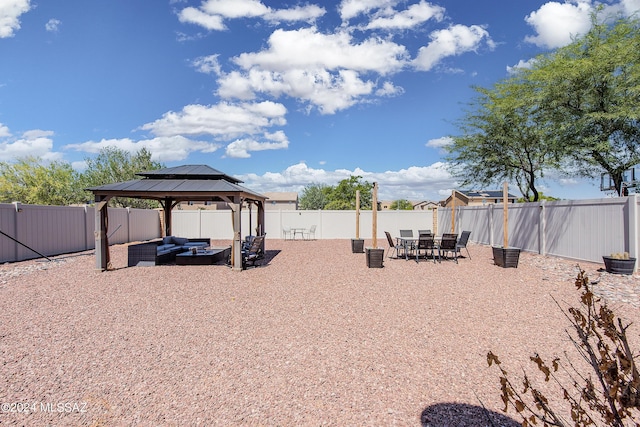 view of yard with a fenced backyard, a gazebo, and an outdoor hangout area