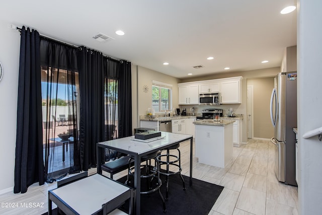 dining room featuring baseboards, visible vents, and recessed lighting