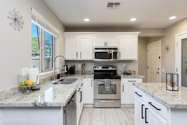 kitchen featuring recessed lighting, a sink, visible vents, white cabinetry, and appliances with stainless steel finishes