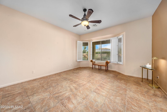 unfurnished room featuring visible vents, baseboards, and a ceiling fan