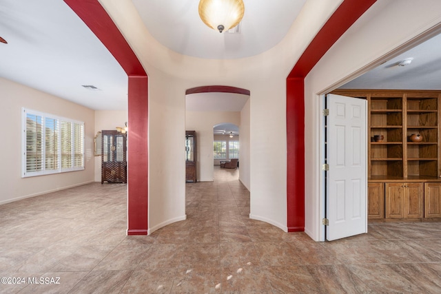 entrance foyer featuring visible vents, arched walkways, and baseboards