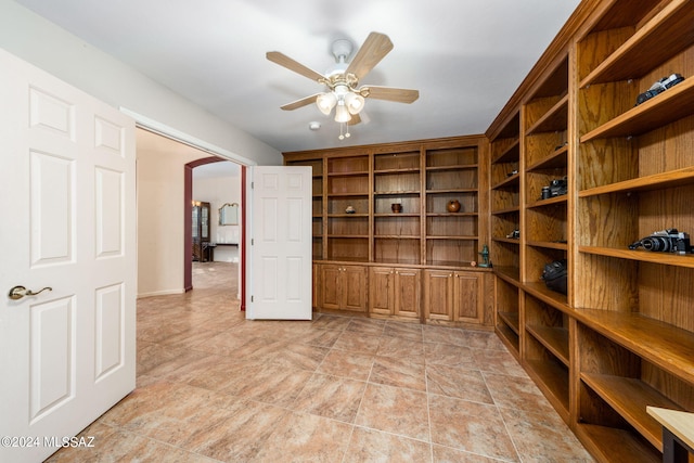 interior space featuring a ceiling fan and arched walkways