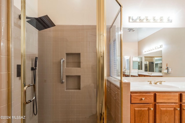 full bathroom with a stall shower and vanity