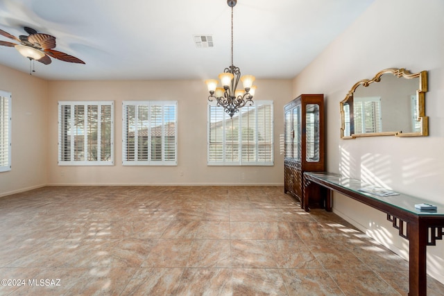 empty room featuring ceiling fan with notable chandelier, visible vents, and baseboards