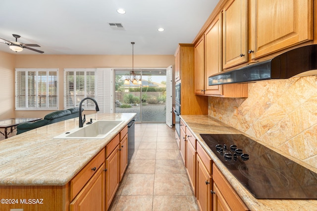 kitchen featuring visible vents, black appliances, a sink, under cabinet range hood, and backsplash