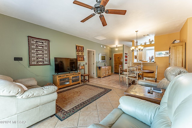 living room with light tile patterned floors and ceiling fan with notable chandelier