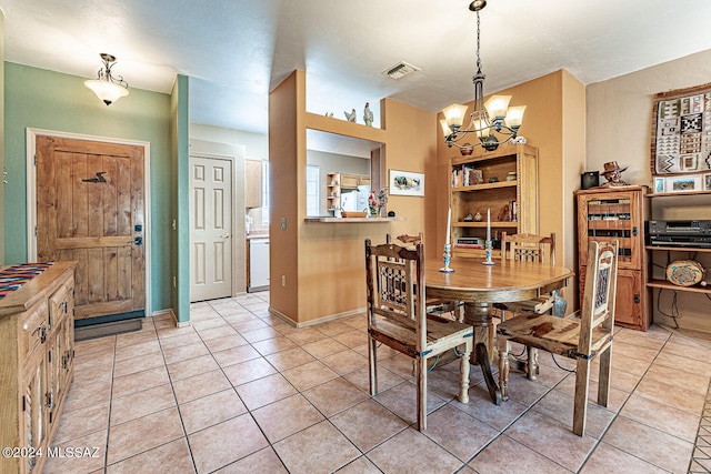 tiled dining room featuring a notable chandelier