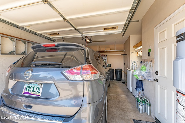 garage with a garage door opener and secured water heater