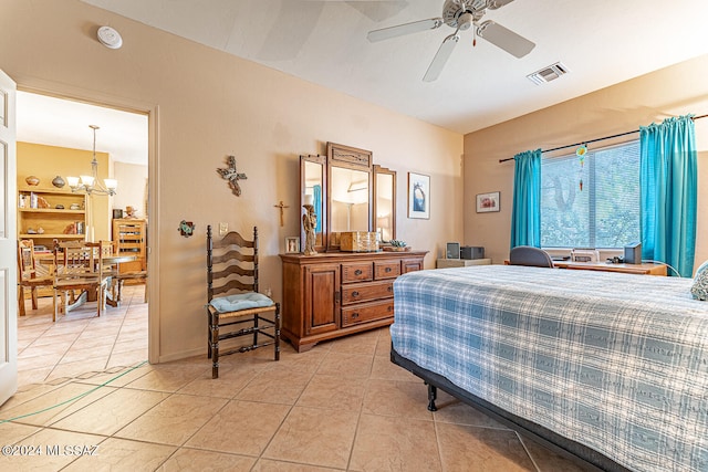 tiled bedroom featuring ceiling fan with notable chandelier