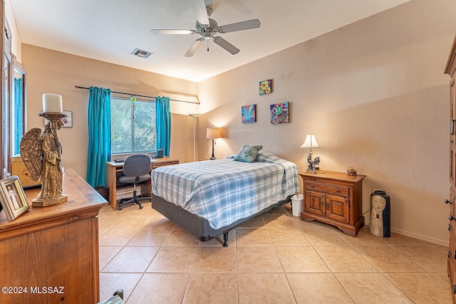 tiled bedroom featuring ceiling fan