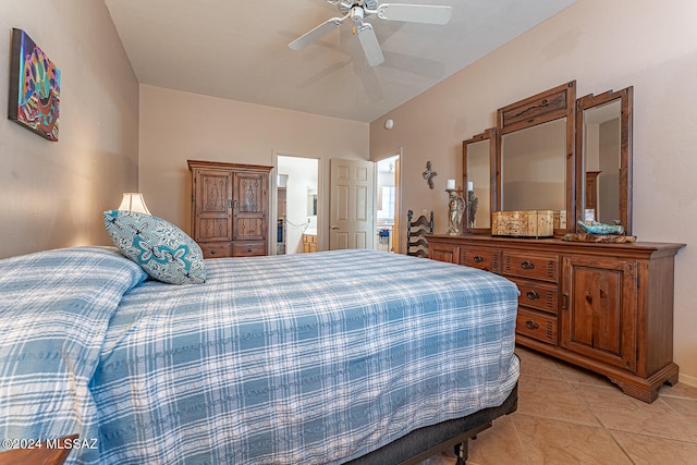 bedroom with ceiling fan, light tile patterned floors, and connected bathroom