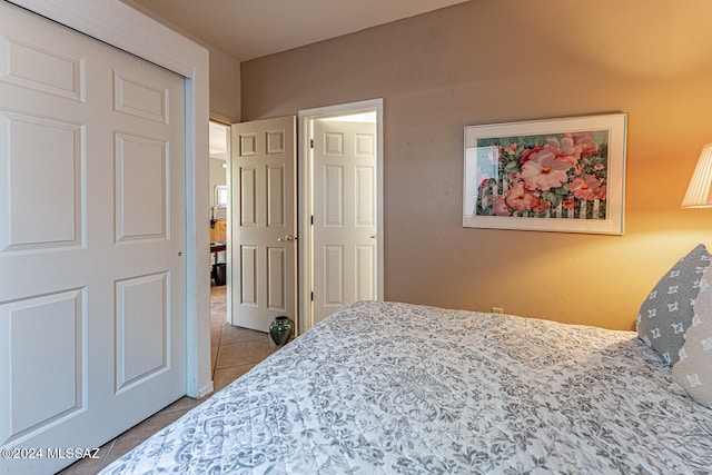 tiled bedroom featuring a closet