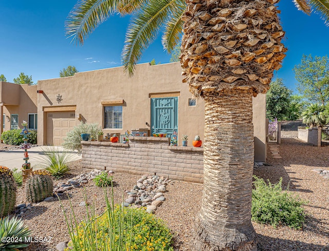 pueblo-style house with a garage