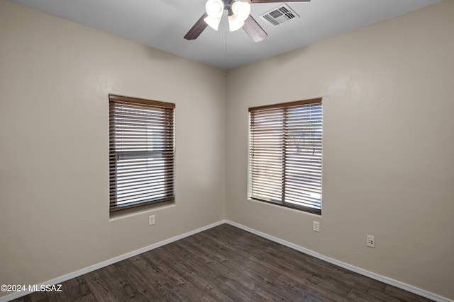 unfurnished room with dark wood-type flooring and ceiling fan