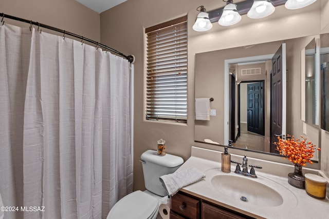 bathroom with vanity, toilet, and a shower with shower curtain