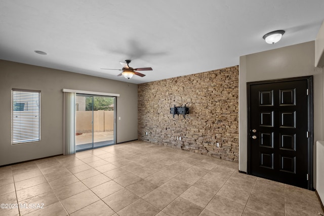 interior space with ceiling fan