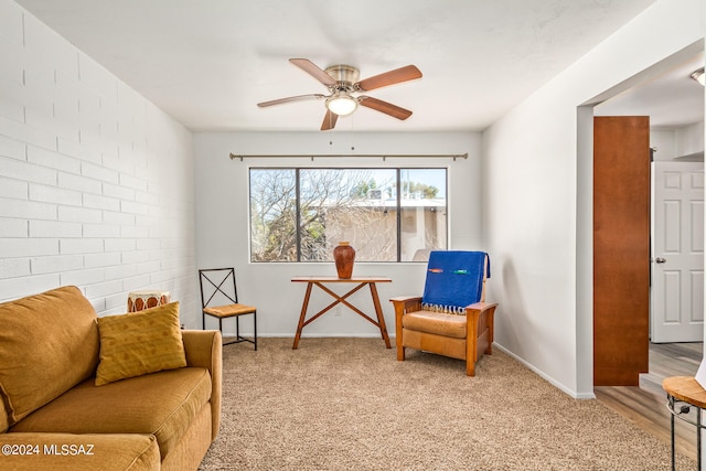 living area featuring light wood-type flooring and ceiling fan