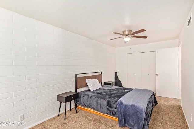 carpeted bedroom featuring a closet and ceiling fan