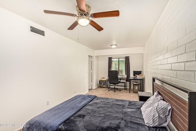 carpeted bedroom with a fireplace and ceiling fan