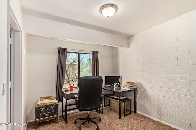 office featuring brick wall and carpet flooring