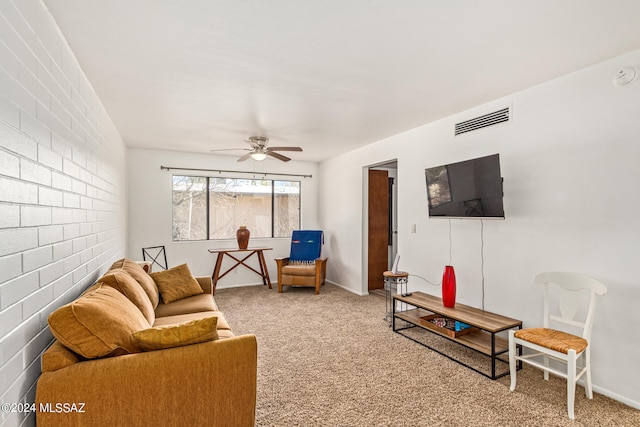 carpeted living room with ceiling fan