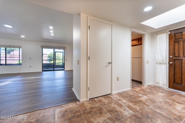 interior space with wood-type flooring and a skylight