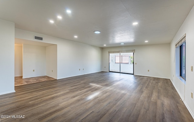 spare room with dark wood-type flooring