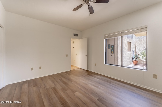 empty room with light wood-type flooring and ceiling fan