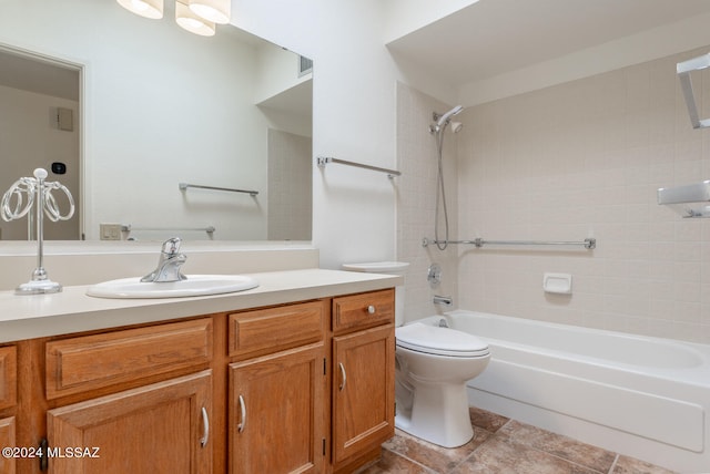 full bathroom featuring tiled shower / bath combo, vanity, and toilet