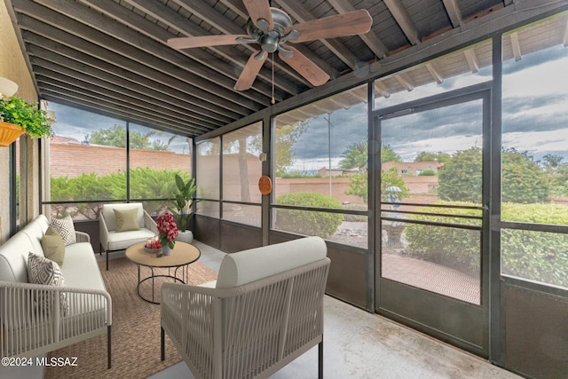 sunroom / solarium with ceiling fan, plenty of natural light, and vaulted ceiling