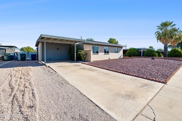 ranch-style home featuring a carport