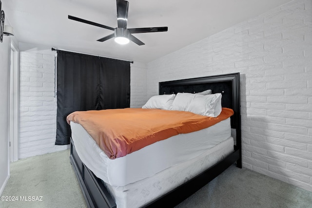 carpeted bedroom with brick wall and ceiling fan