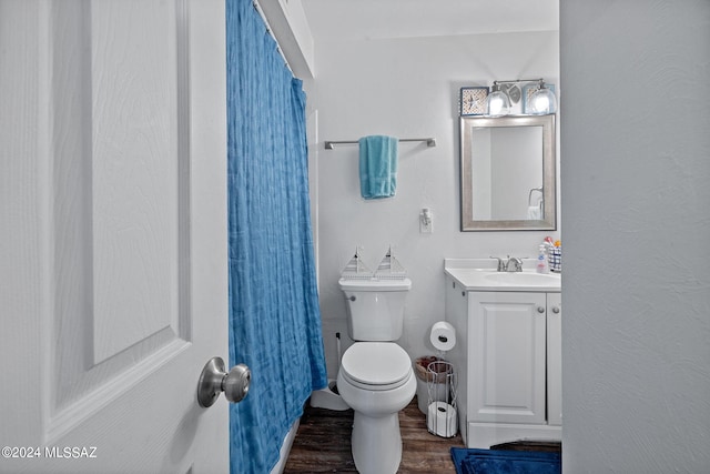 bathroom with a shower with shower curtain, vanity, toilet, and hardwood / wood-style flooring