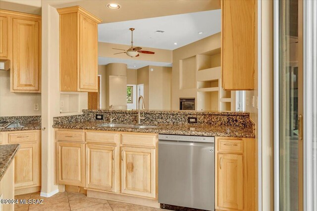 kitchen with dark stone counters, dishwasher, ceiling fan, and sink