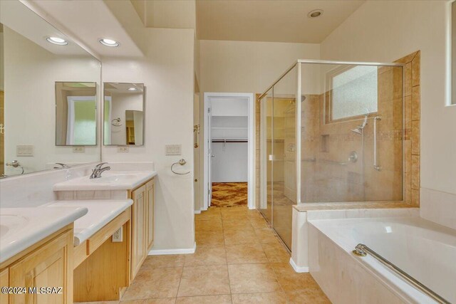 bathroom with tile patterned floors, vanity, and separate shower and tub