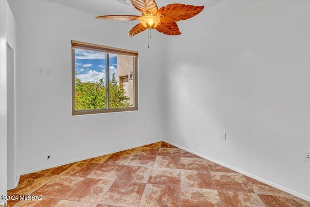 spare room with ceiling fan