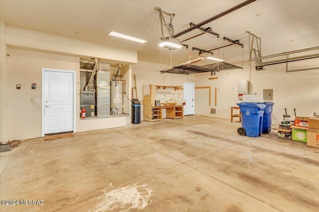 garage featuring water heater and a garage door opener