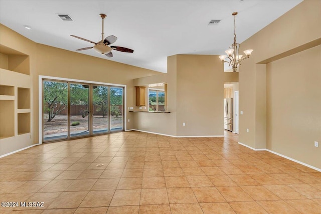 empty room with ceiling fan with notable chandelier, light tile patterned floors, built in features, and high vaulted ceiling