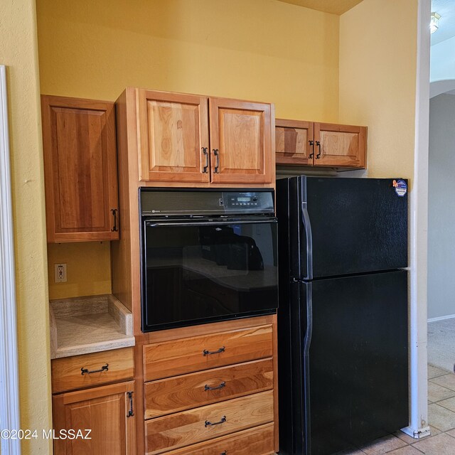 kitchen featuring black appliances, sink, tasteful backsplash, and light tile patterned floors