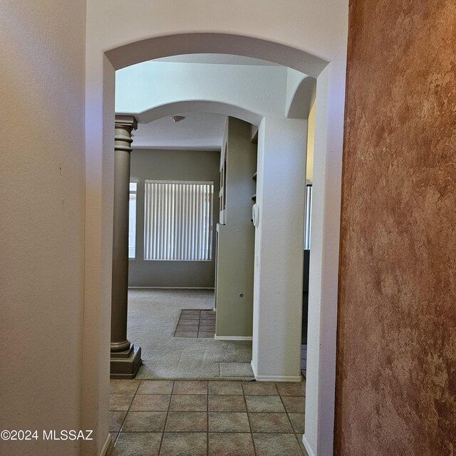 workout area featuring a fireplace, ceiling fan, ornate columns, and carpet floors