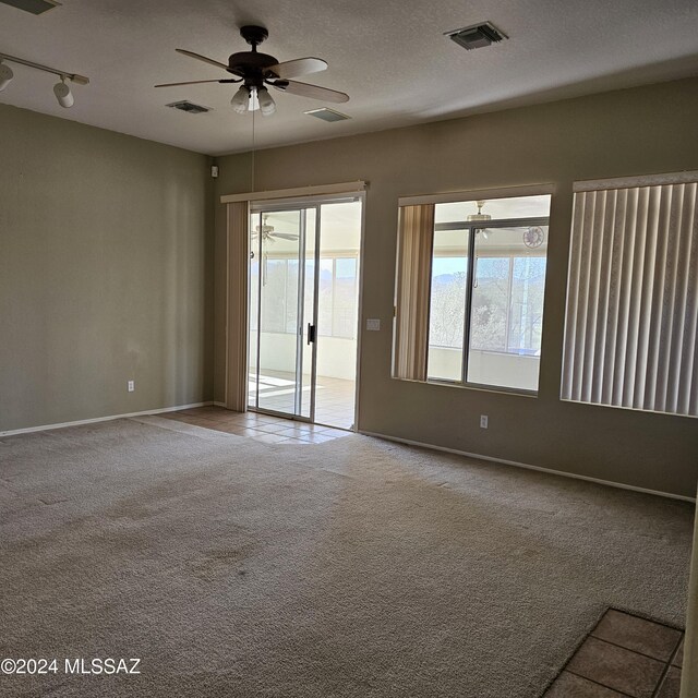 unfurnished sunroom with ceiling fan