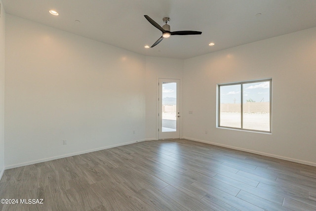 unfurnished room featuring ceiling fan and light hardwood / wood-style floors