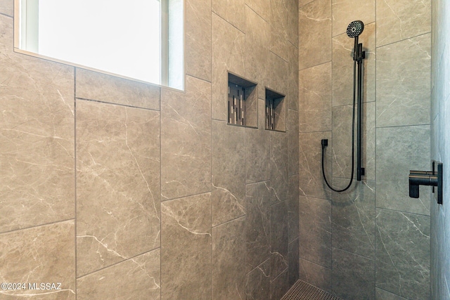 bathroom with a tile shower