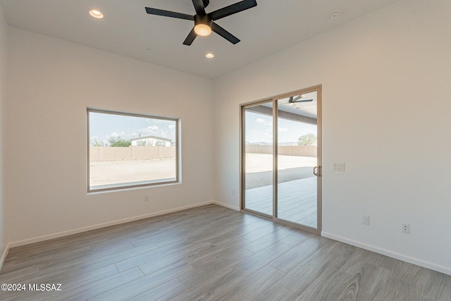 spare room featuring ceiling fan and light hardwood / wood-style floors