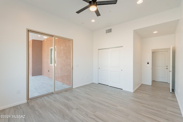 unfurnished bedroom featuring light hardwood / wood-style flooring, ceiling fan, and access to outside