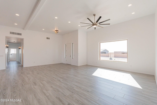 interior space featuring light wood-type flooring, beam ceiling, and ceiling fan